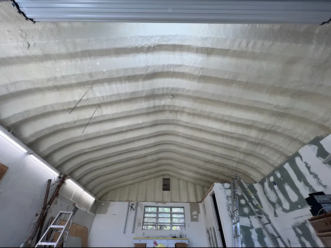 Spray polyurethane foam applied to the underside of a metal roof deck in Landover